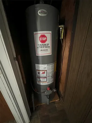a view of a backyard with lawn chairs under an umbrella