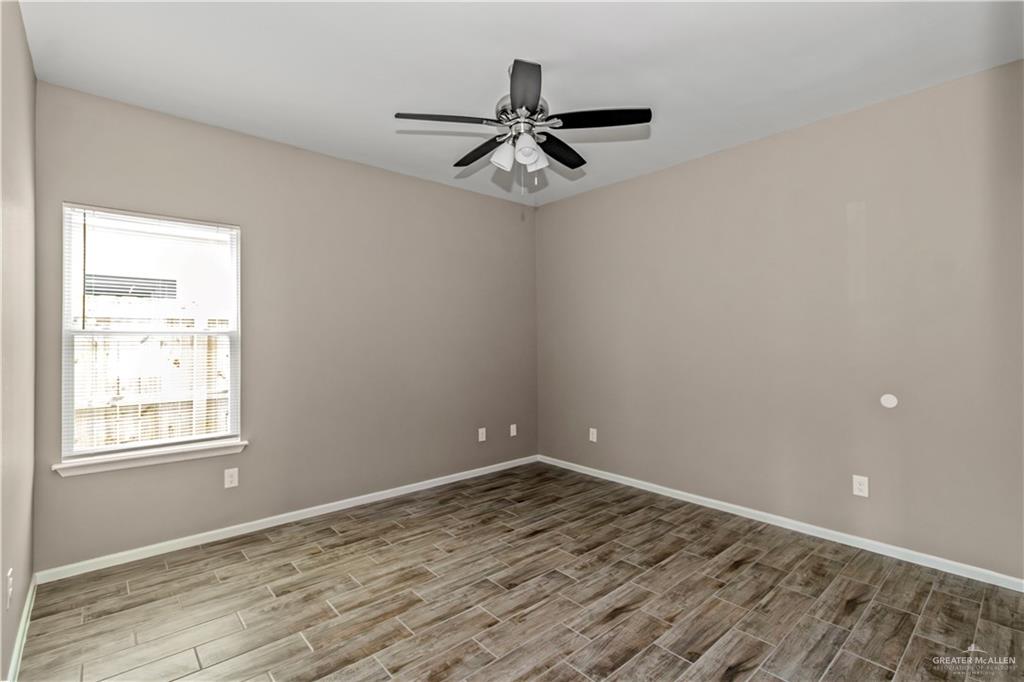 1409 Beverly Avenue Weslaco, TX 78596 - Photo 7 of 15 Unfurnished room featuring ceiling fan and wood-type flooring