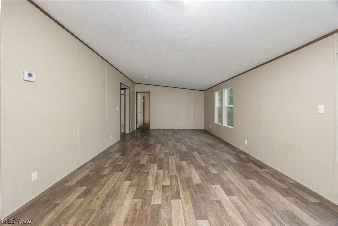 7455 Stanleyville Road Whipple, OH 45788 - Photo 23 of 37 Spacious interior with wood-finish flooring, light-toned wall panels, and multiple windows providing natural light