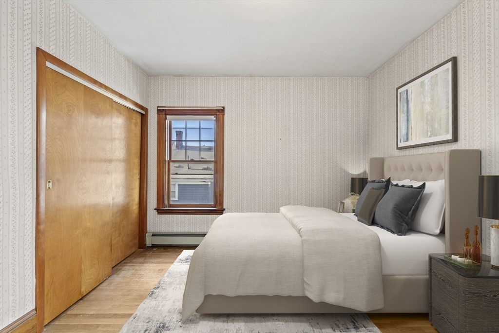 12 Foster Street Everett, MA 02149 - Photo 18 of 29 a bedroom with a bed and a night stand