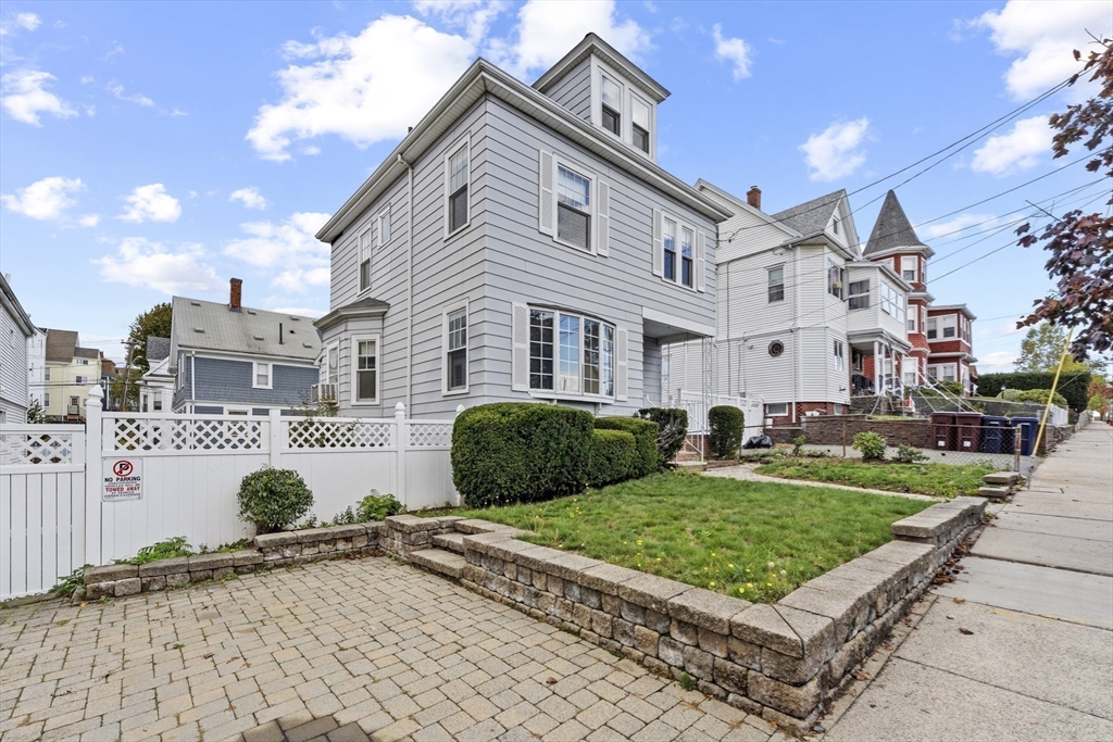 12 Foster Street Everett, MA 02149 - Photo 2 of 29 a front view of a house with a garden and plants