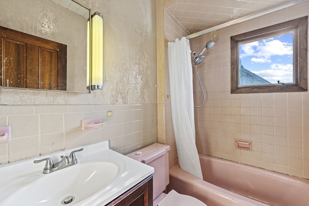 12 Foster Street Everett, MA 02149 - Photo 27 of 29 a bathroom with a sink and a bathtub