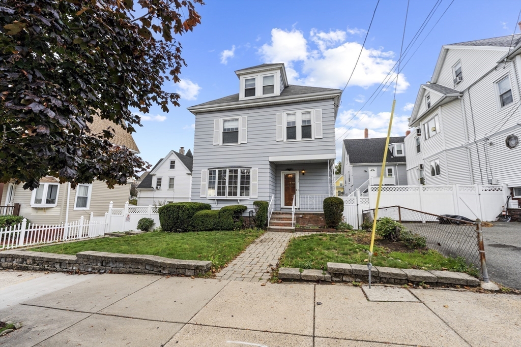 12 Foster Street Everett, MA 02149 - Photo 4 of 29 a front view of a house with a yard
