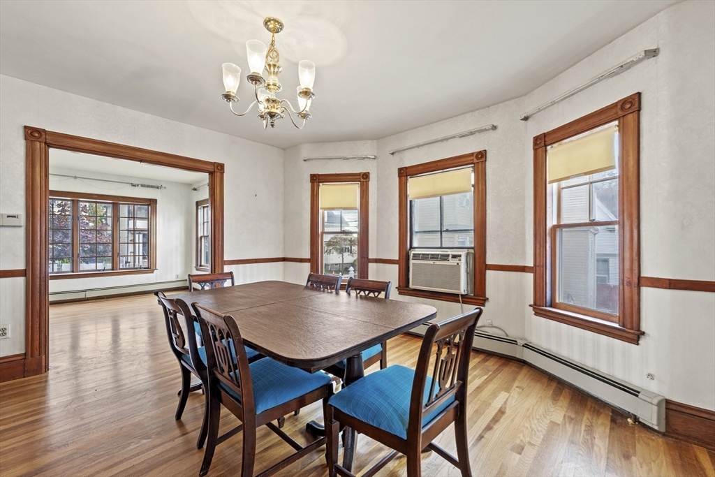 12 Foster Street Everett, MA 02149 - Photo 10 of 29 a view of a dining room with furniture wooden floor and chandelier
