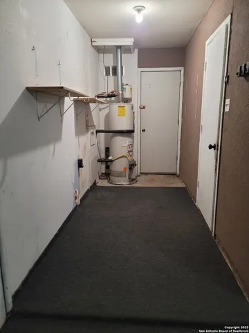 a view of a storage & utility room with fridge and wooden floor