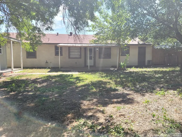 a backyard of a house with yard and outdoor seating