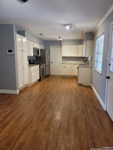 a kitchen with stainless steel appliances refrigerator sink and cabinets