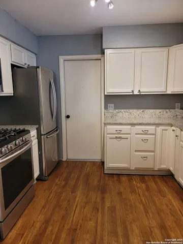 a kitchen with a sink stove and refrigerator