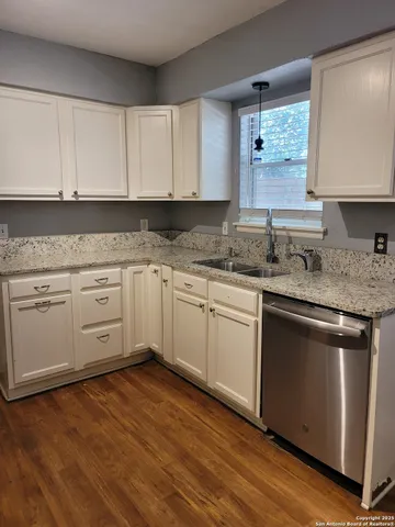a kitchen with stainless steel appliances granite countertop a sink stove and cabinets