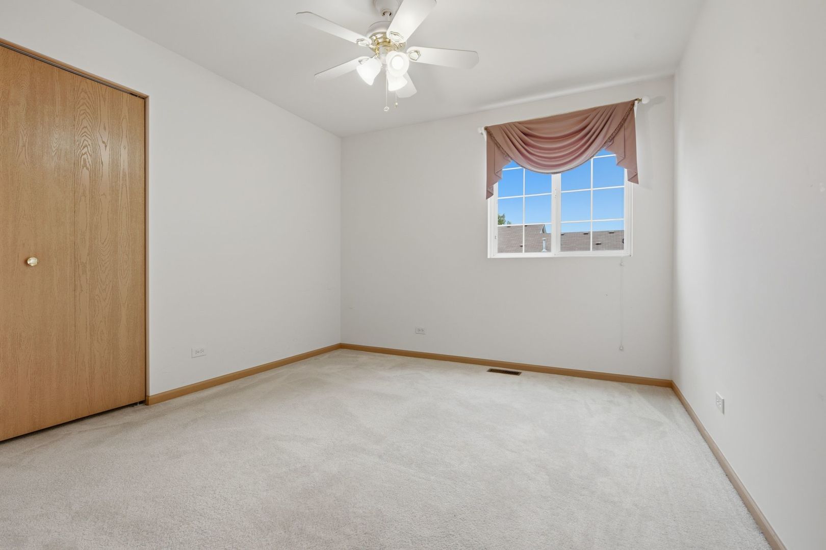1758 Edith Lane Aurora, IL 60504 - Photo 9 of 28 an empty room with windows and fan