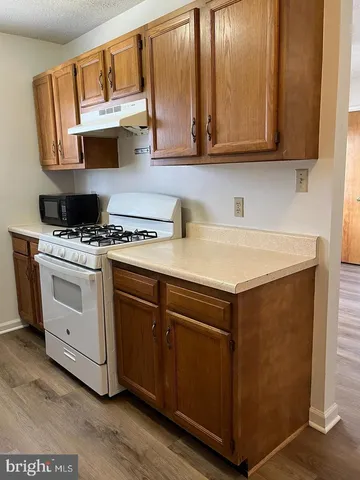 a kitchen with appliances cabinets and a counter top space