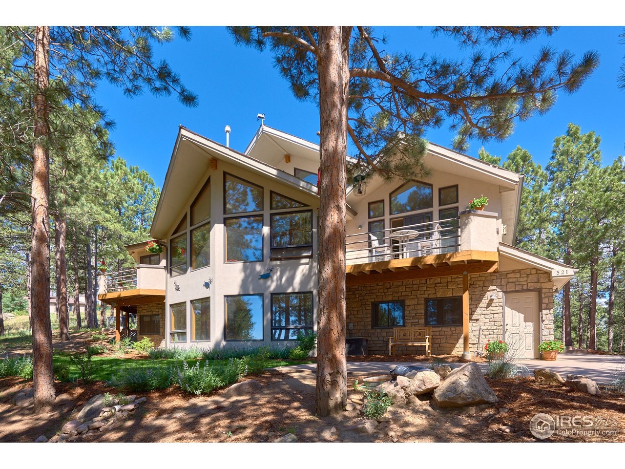 321 Peakview Road Boulder, CO 80302 - Photo 1 of 40 a front view of a house with a garden