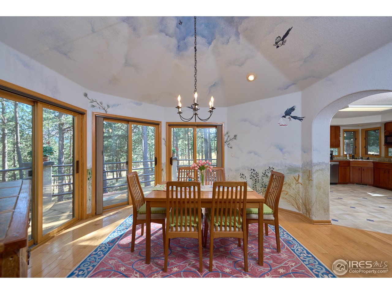 321 Peakview Road Boulder, CO 80302 - Photo 15 of 40 a view of a dining room with furniture window and wooden floor