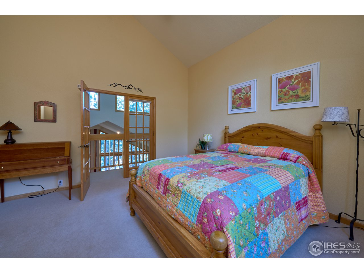 321 Peakview Road Boulder, CO 80302 - Photo 32 of 40 a bedroom with a bed and wooden floor