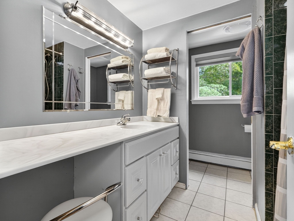 25 Lee Road Wayland, MA 01778 - Photo 8 of 24 a bathroom with a sink a vanity and a large mirror