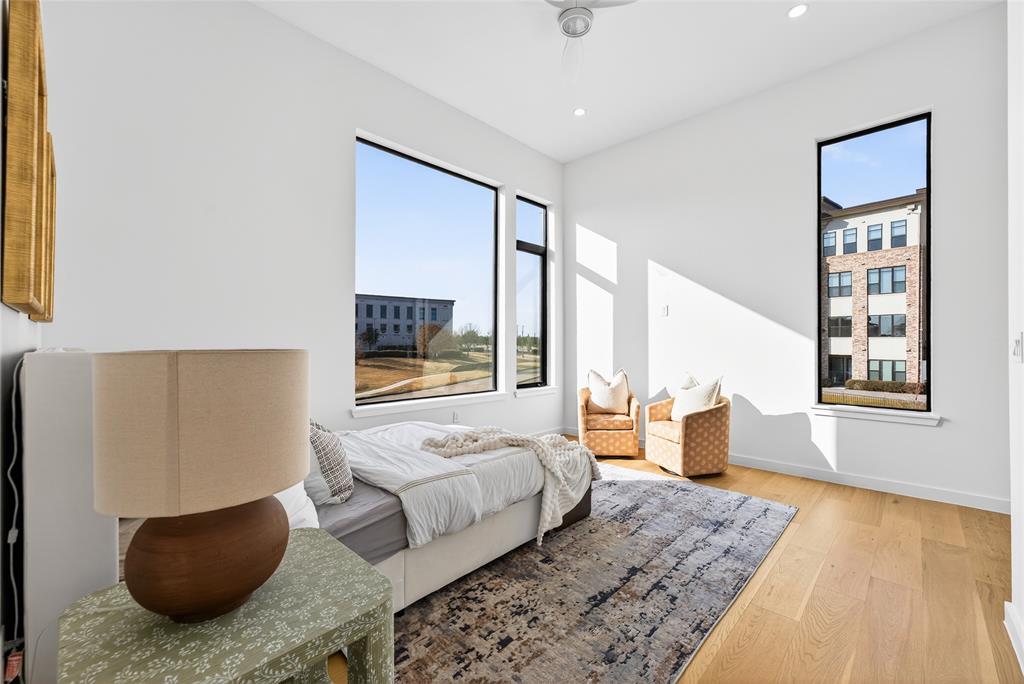 1111 Raiford Road, Unit 112 Carrollton, TX 75007 - Photo 22 of 30 a bedroom with a bed and wooden floor