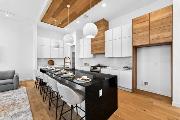 a kitchen with sink stove and cabinets