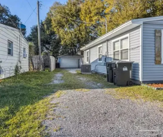 a view of a house with backyard and a tree