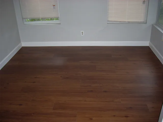 a view of a room with wooden floor