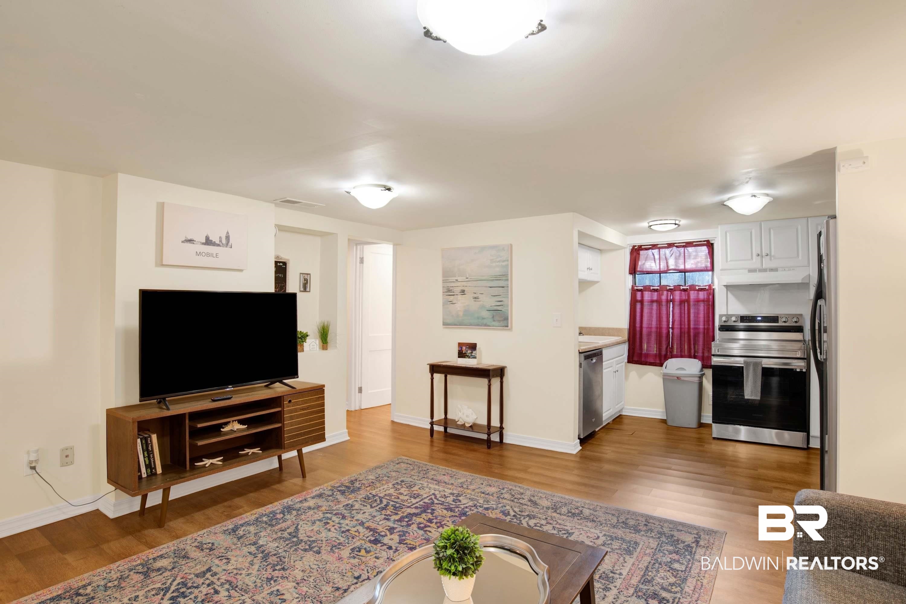 1141 Montauk Avenue Mobile, AL 36604 - Photo 8 of 15 Living room featuring baseboards, visible vents, and wood finished floors