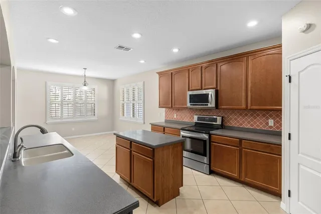 a kitchen with a sink stove and microwave