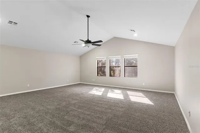 a view of an empty room with windows