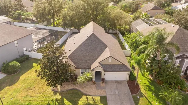 a aerial view of a house with a yard and potted plants