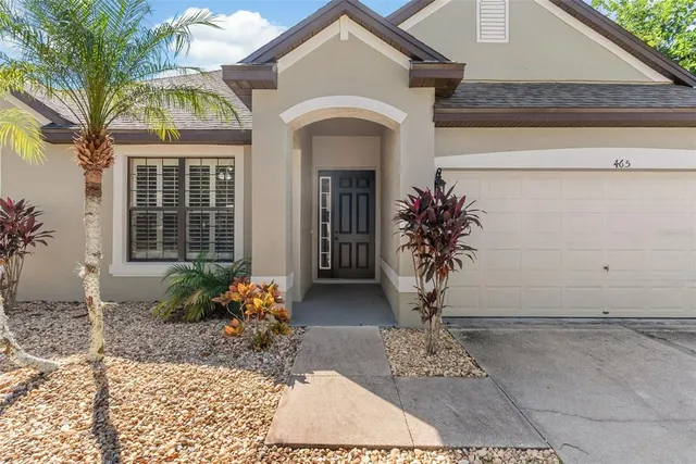 a view of a house with potted plants