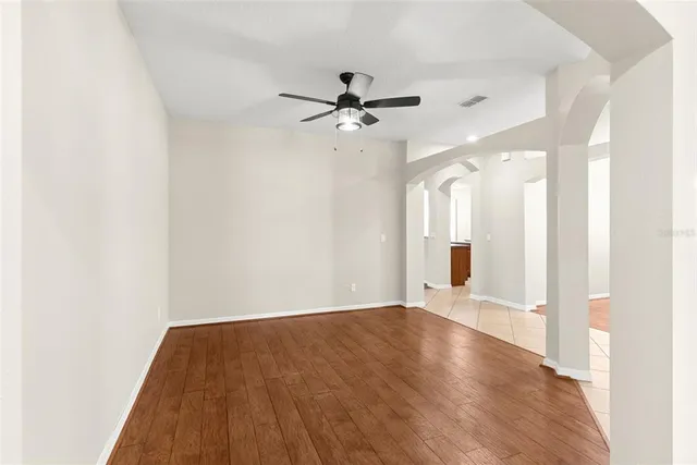 an empty room with fan and a ceiling fan