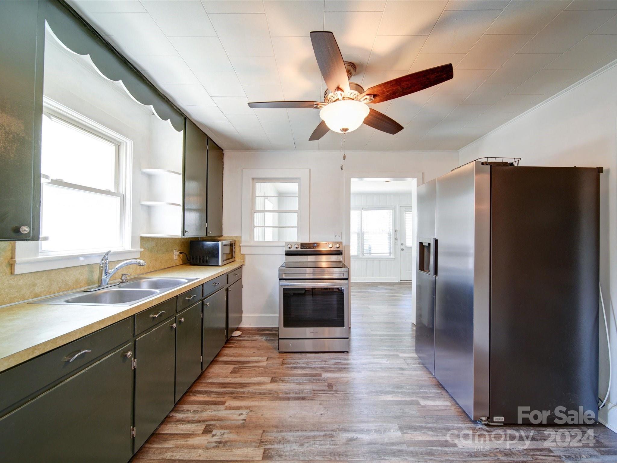 1102 White Store Road Wadesboro, NC 28170 - Photo 13 of 35 a kitchen with stainless steel appliances a stove a refrigerator and a sink