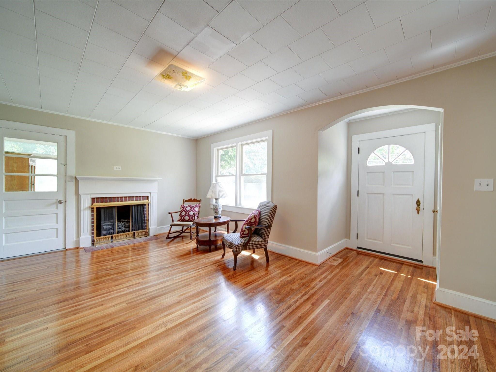 1102 White Store Road Wadesboro, NC 28170 - Photo 17 of 35 a view of a livingroom with furniture a fireplace wooden floor and a window