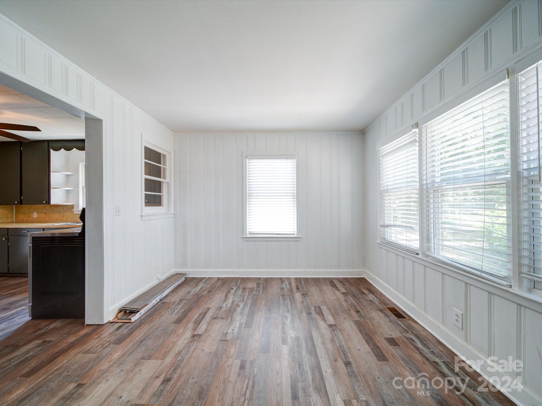1102 White Store Road Wadesboro, NC 28170 - Photo 9 of 35 a view of an empty room with wooden floor and a window