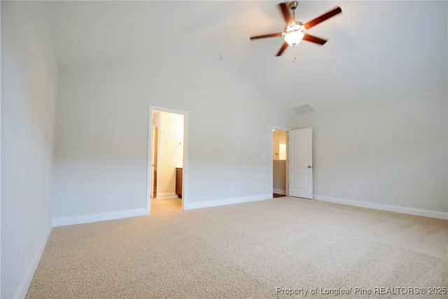 an empty room with a window and a ceiling fan