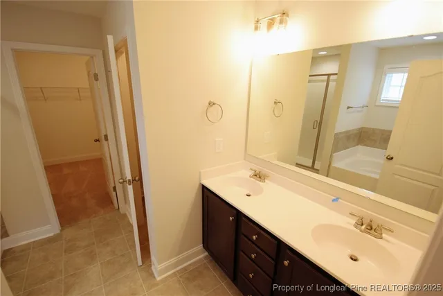 a bathroom with a double vanity sink a mirror and a shower