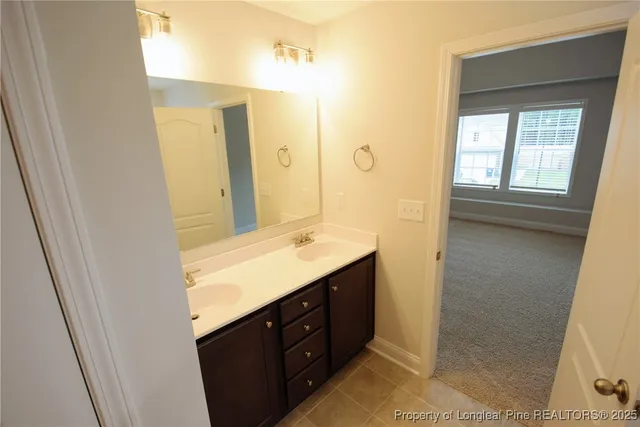 a bathroom with a double vanity sink a mirror and a shower