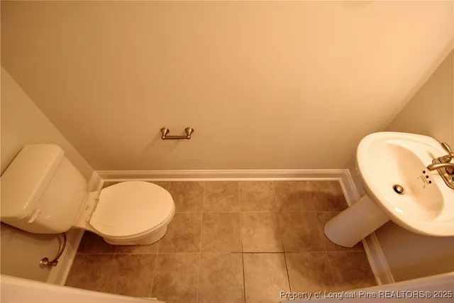 a bathroom with a toilet and a mirror