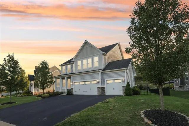 a front view of a house with a garden
