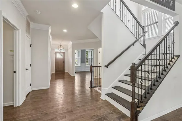 a view of entryway with wooden floor and stairs