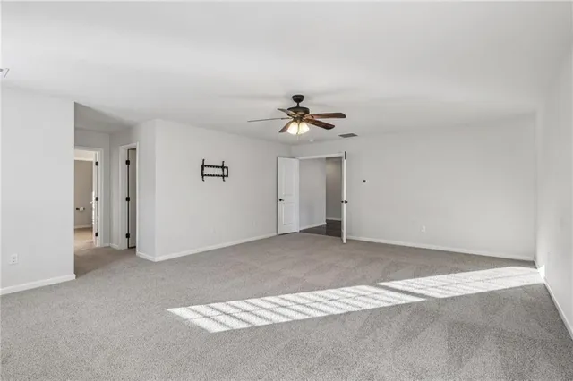a view of a livingroom with a chandelier fan