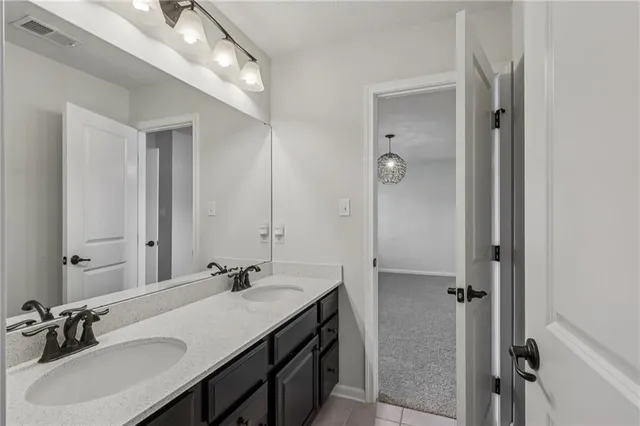 a bathroom with a sink double vanity and a mirror