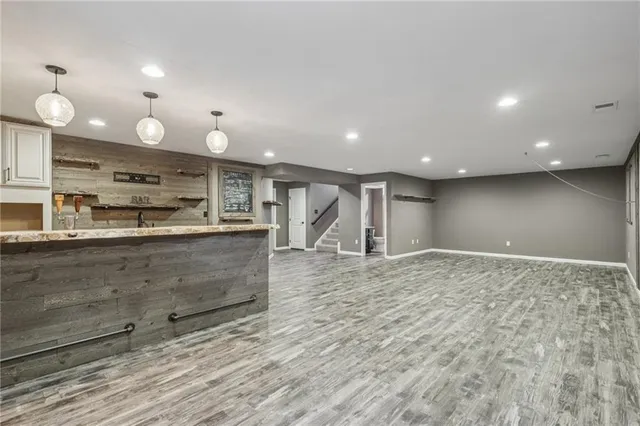 a large kitchen with kitchen island a sink stainless steel appliances and cabinets