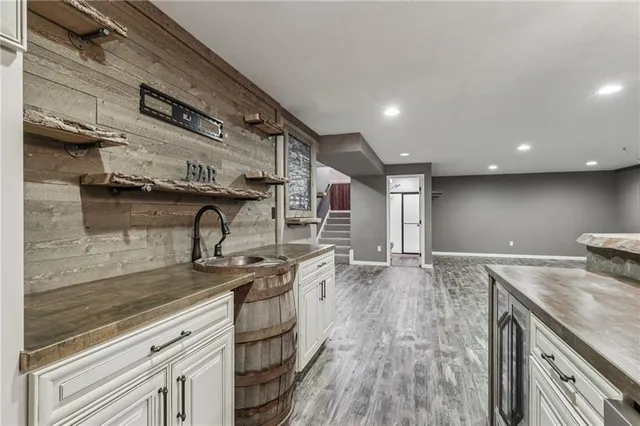 a kitchen with stainless steel appliances granite countertop a sink and stove