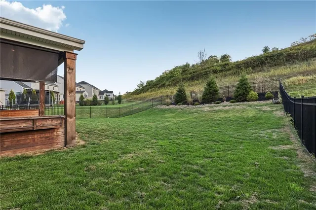 a view of a backyard with lawn chairs and a small yard