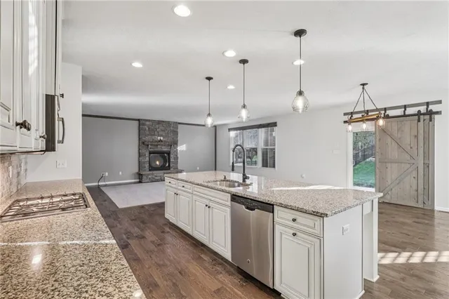 a kitchen with stainless steel appliances granite countertop a sink and a granite counter tops