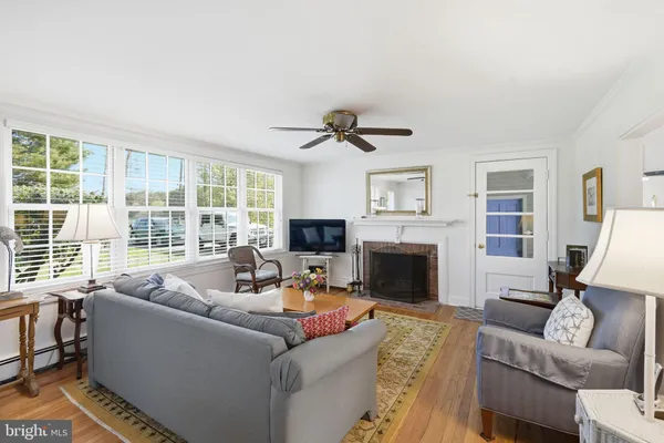 a living room with furniture large window and a fireplace