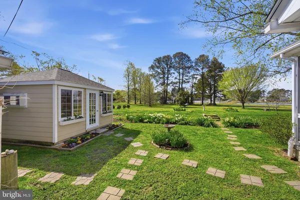 a view of a house with yard and a garden