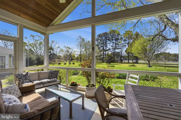 a view of a chairs and table in patio with a small yard