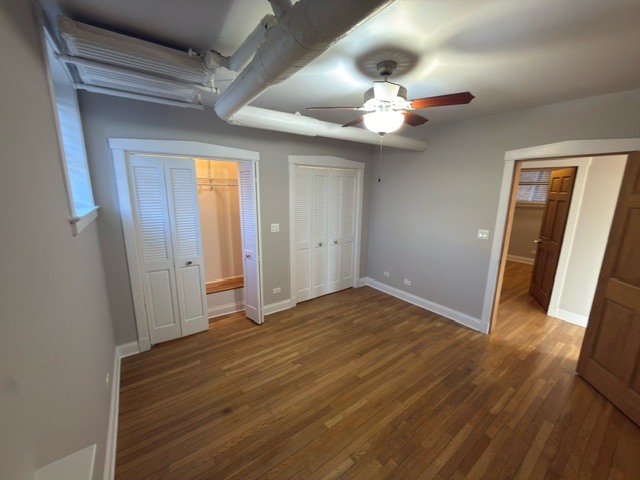 2147 West Lunt Avenue, Unit G Chicago, IL 60645 - Photo 11 of 16 wooden floor in an empty room with a window
