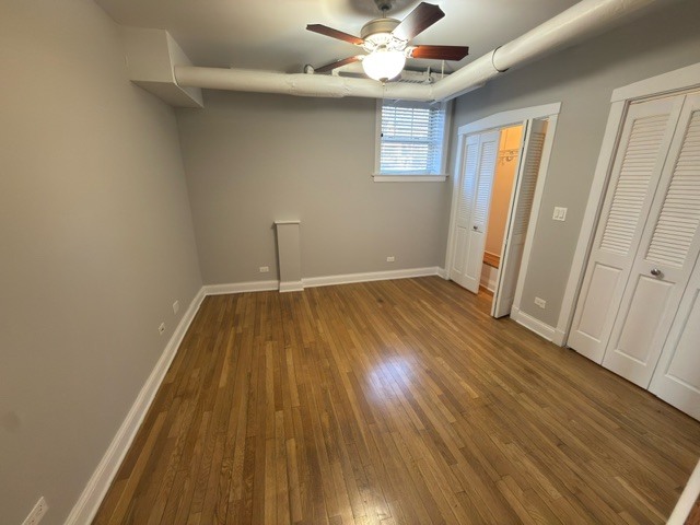 2147 West Lunt Avenue, Unit G Chicago, IL 60645 - Photo 12 of 16 wooden floor in an empty room with a window