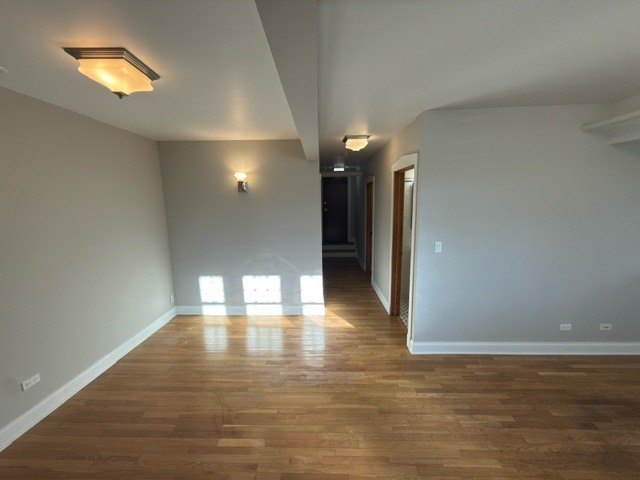 2147 West Lunt Avenue, Unit G Chicago, IL 60645 - Photo 7 of 16 a view of an empty room with a window